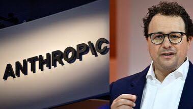Anthropic logo on a sign beside an Anthropic executive speaking at an event
