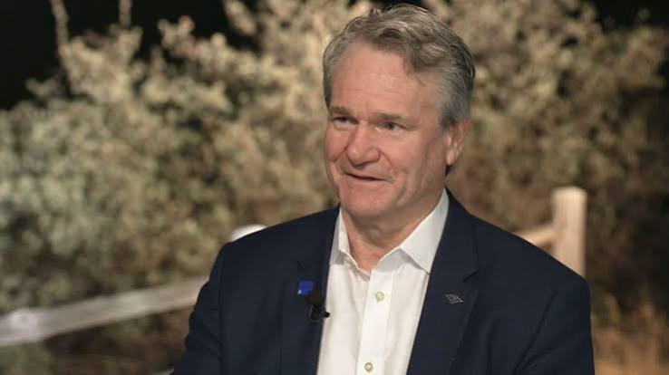 Bank of America chief executive Brian Moynihan smiles during a television interview outdoors at night