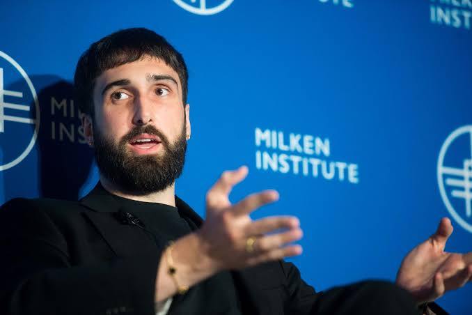 Cohere co-founder and chief executive Aidan Gomez speaking at a Milken Institute panel