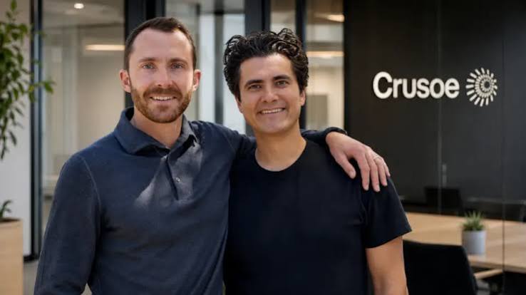 Crusoe co-founders standing in front of the company logo at its office