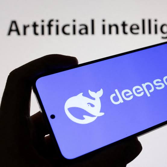 The red DeepSeek whale over a humanoid robot silhouette on a black field, representing DeepSeek's move from AI models into robotics