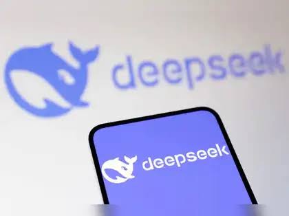 The DeepSeek whale logo on a smartphone screen in front of a larger blurred DeepSeek logo, as DeepSeek open-sources six components for Huawei Ascend chips
