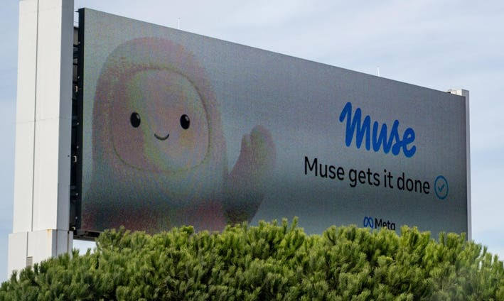 A roadside billboard for Meta's Muse AI assistant showing a smiling cartoon character and the slogan Muse gets it done, behind green shrubs