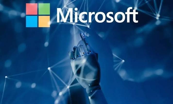 Microsoft logo above a robotic hand reaching toward a glowing network of connected nodes on a blue background
