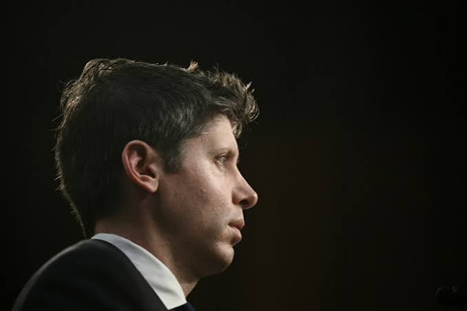 OpenAI CEO Sam Altman in profile against a dark background