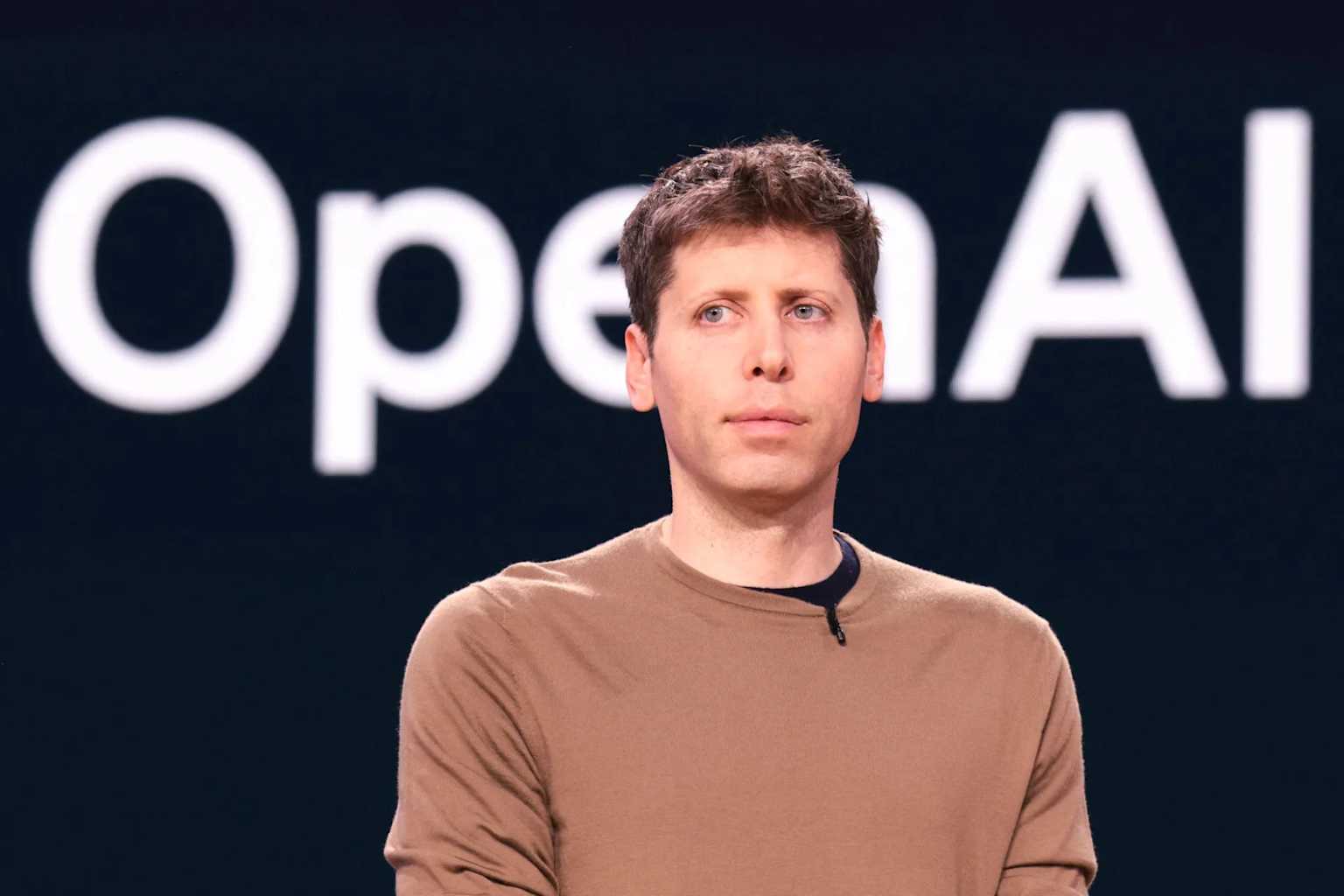Sam Altman against a black event-horizon gradient, illustrating his claim that the singularity has arrived