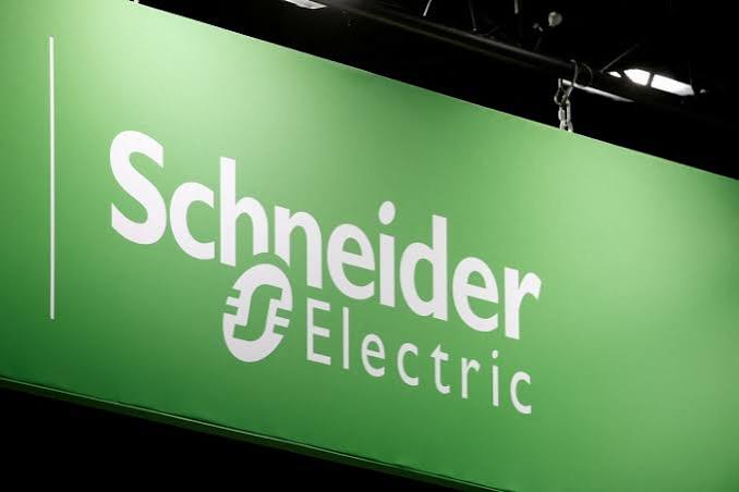 Schneider Electric logo in white on a green banner at a trade event