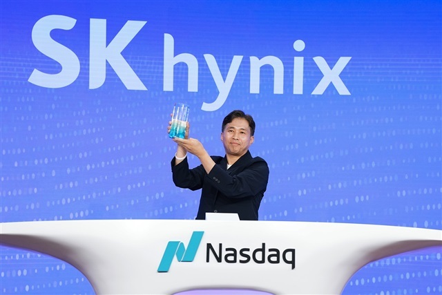 Stacked high-bandwidth memory chips rising like a skyline against a red upward stock arrow