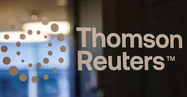 The Thomson Reuters logo, its dot-cluster emblem and wordmark, on a glass office panel