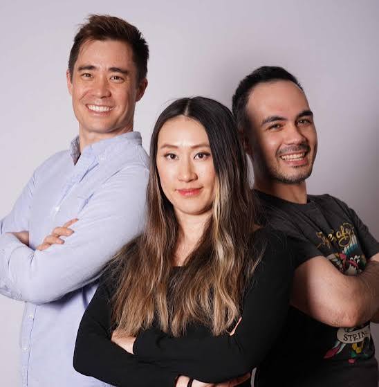 TypeSafe AI's three co-founders standing with arms crossed against a light grey studio backdrop